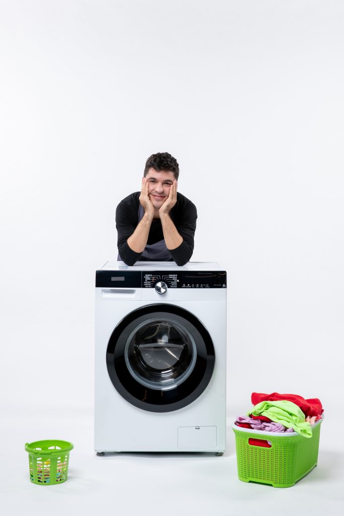 front-view-young-male-with-washer-dirty-clothes-white-wall