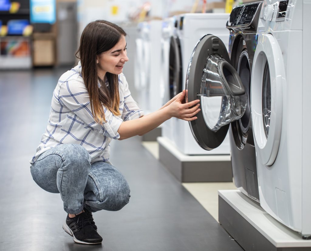 young-woman-store-chooses-washing-machine-concept-shopping