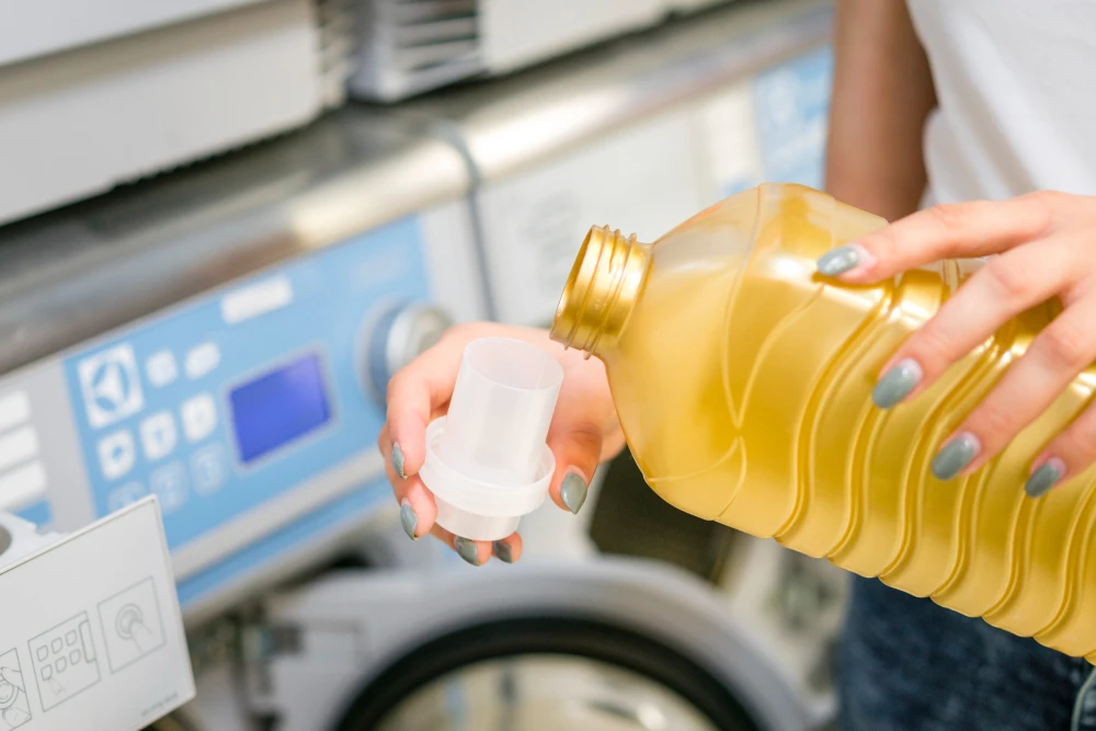 woman pouring detergent-cap