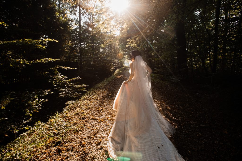 bride-long-wedding-dress-goes-forest-path