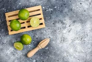 fresh-key-limes-with-wooden-citrus-juicer (1)